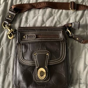 Small dark brown leather coach cross body purse.